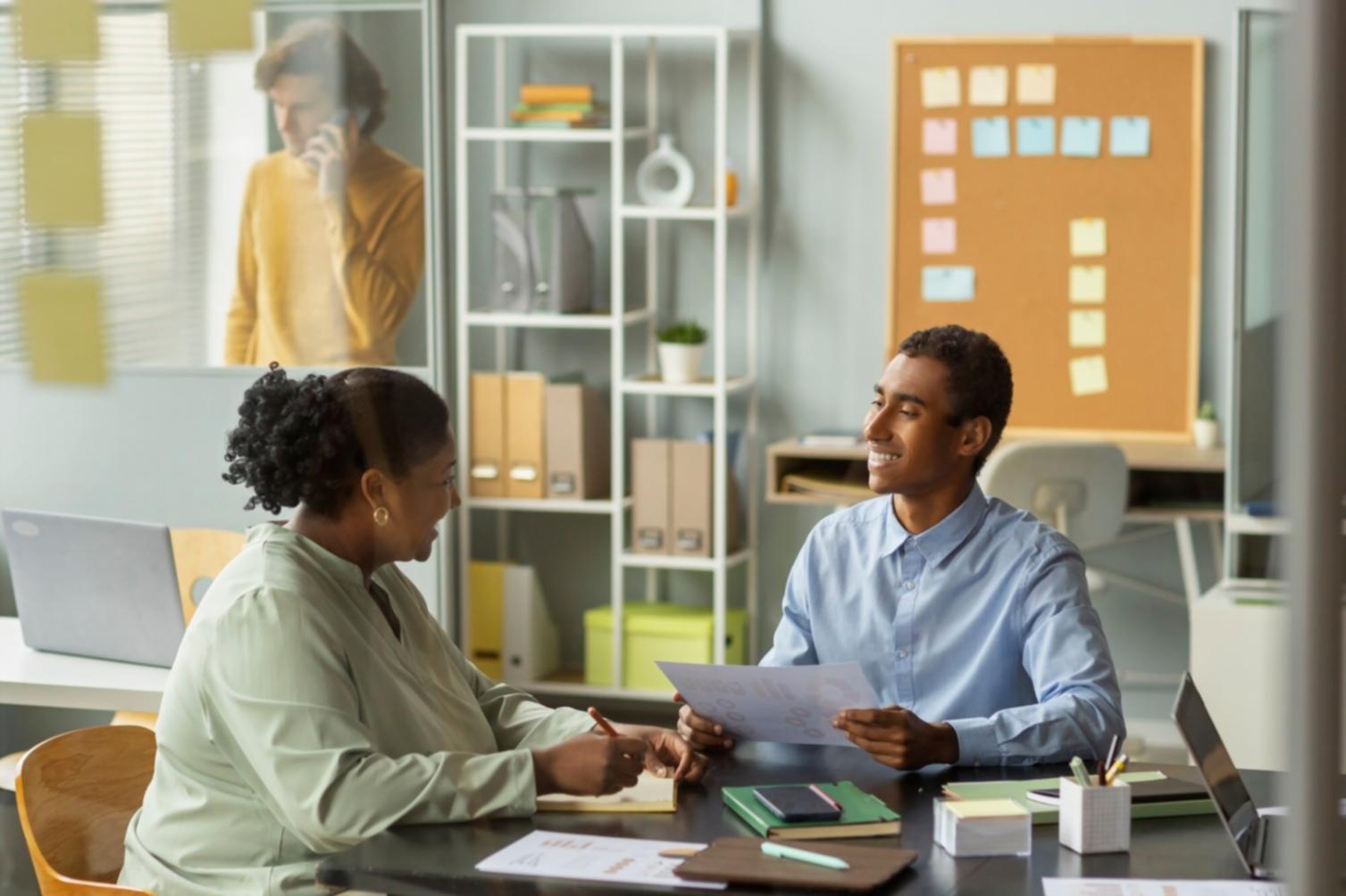 Professional examining budget workflow documentation in modern office environment